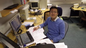 Yun Ting in his natural habitat. Why use only one screen when you can use three?